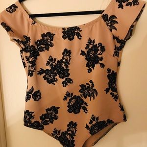Tan body suit with black velvet flower detail